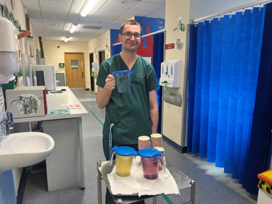 Image shows a man holding a jug of water