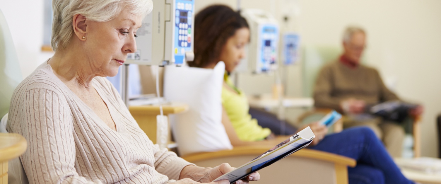 Patients sitting in chairs and reading while having treatment