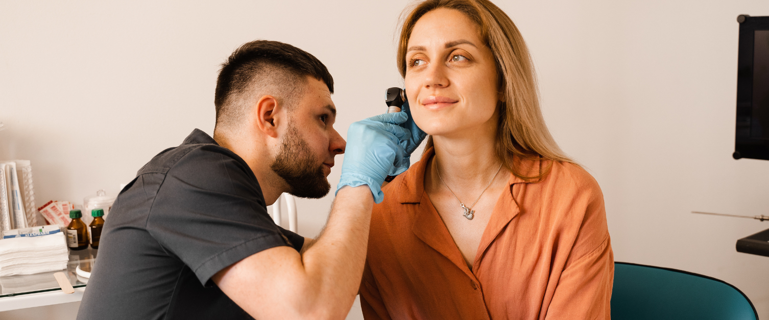 Image shows a person attending an audiology appointment