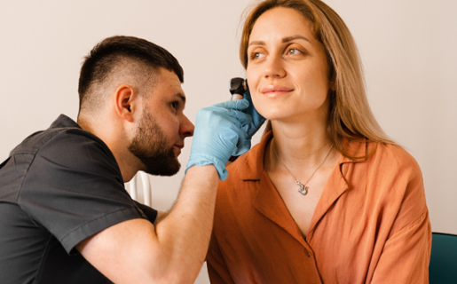 Image shows a person attending an audiology appointment