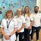 Virtual ward physiotherapists stood in front of a mural