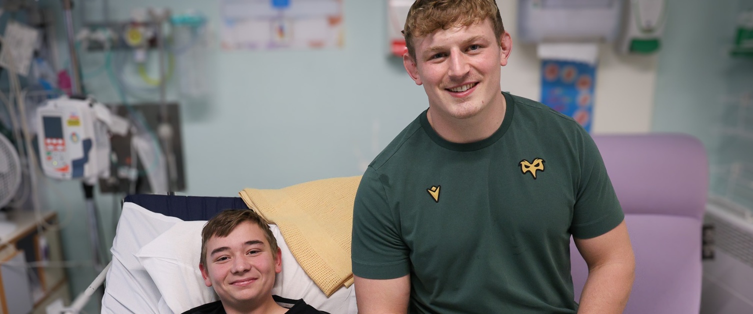 Jac Morgan pictured with Finian Gleaves, 14, who is holding a selection box.