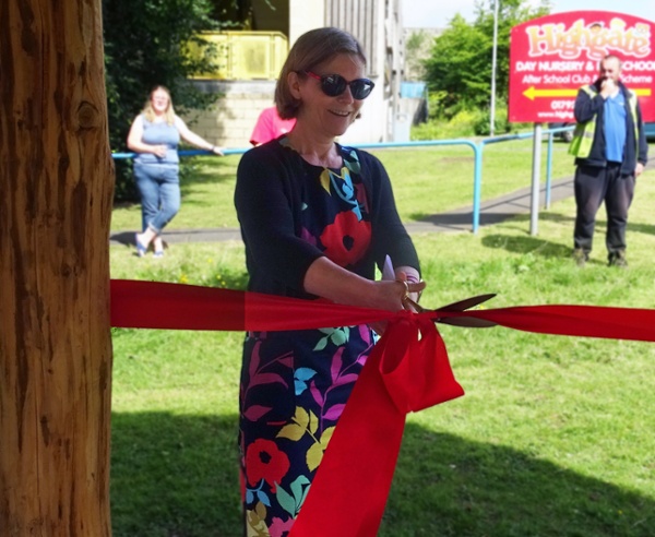 Woman cutting a ribbon 