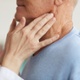 Image shows a person having a neck examination.