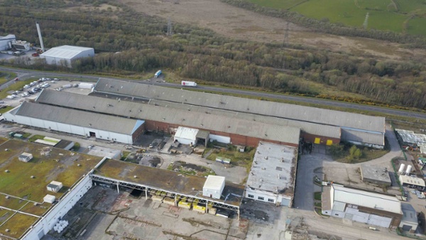 Image is an aerial shot of the large Elba factory building.
