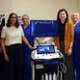 Image shows a group of clinicians with an ultrasound machine.