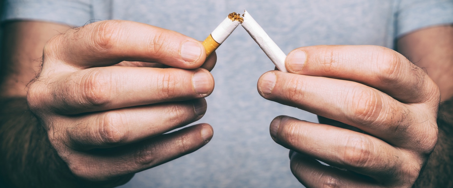 Man snapping a cigarette in half