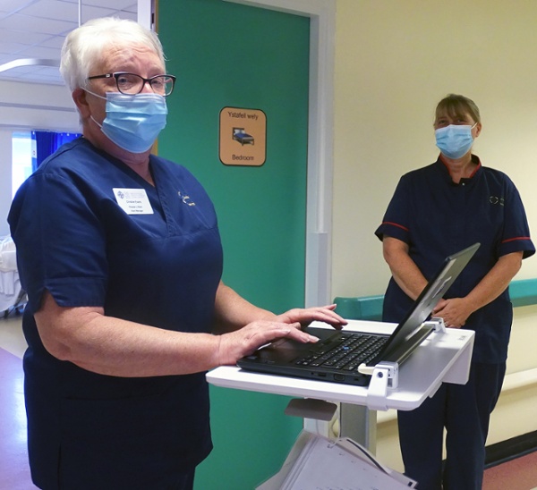 Two nurses in a hospital corridor