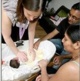 Parents receiving help to care for their baby
