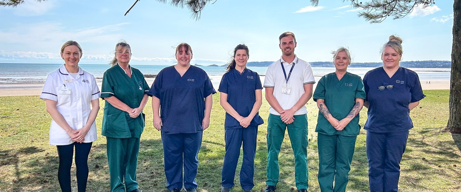 Members of the virtual ward stood in front of a beach