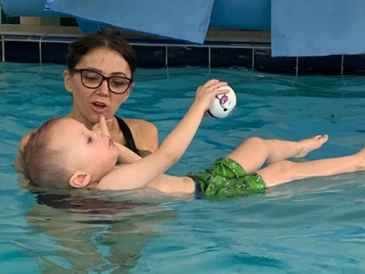 Image shows a mother and baby in a pool