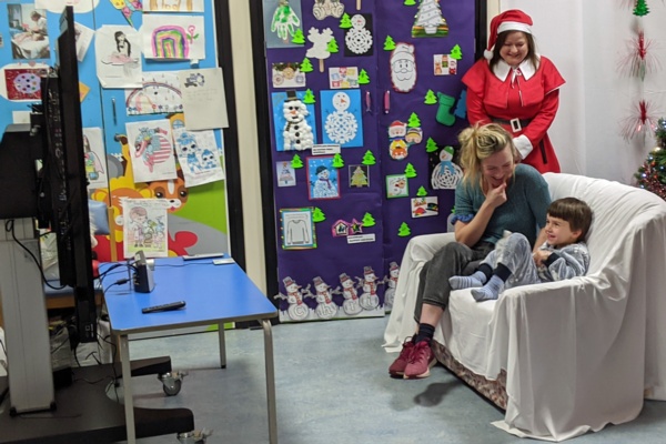 Yanni and mum Pearl speak to Santa using a webcam and television in Ward M