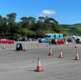 Photo shows a car park with cones set up to mark three lanes. The Immbulance is parked nearby.