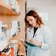 A pharmacist writing in a notebook