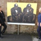 Staff view the art work at the MVC