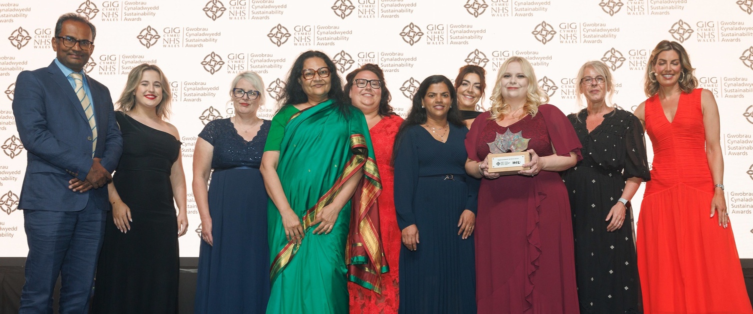 Image shows a group of people standing on a stage