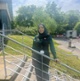 Image shows a woman standing next to a hand rail
