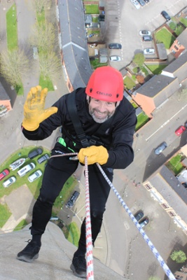 Image shows a man abseiling