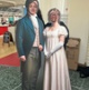 Image shows two people standing in a cardboard cut out