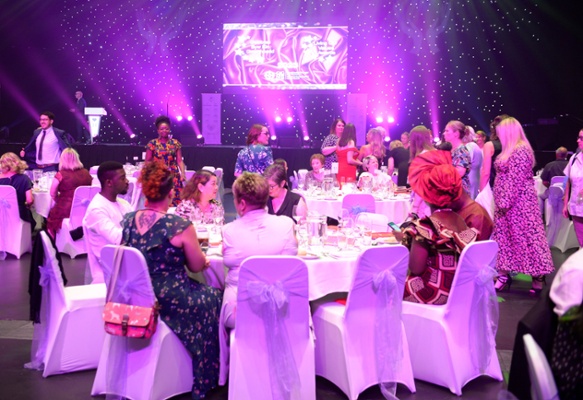 Image shows people sitting at a table