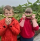 Images show two children holding vegetables in front of their faces