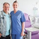 Image shows a patient and a nurse in a hospital room.