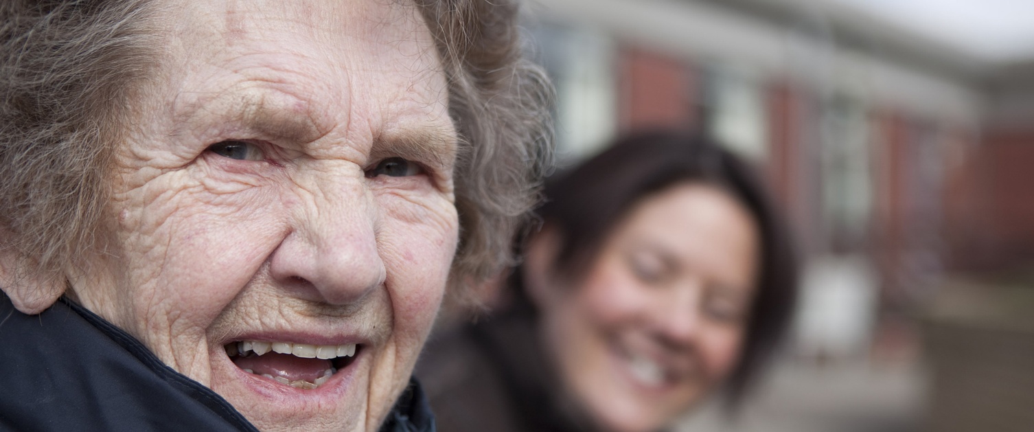 An older woman and younger woman smiling