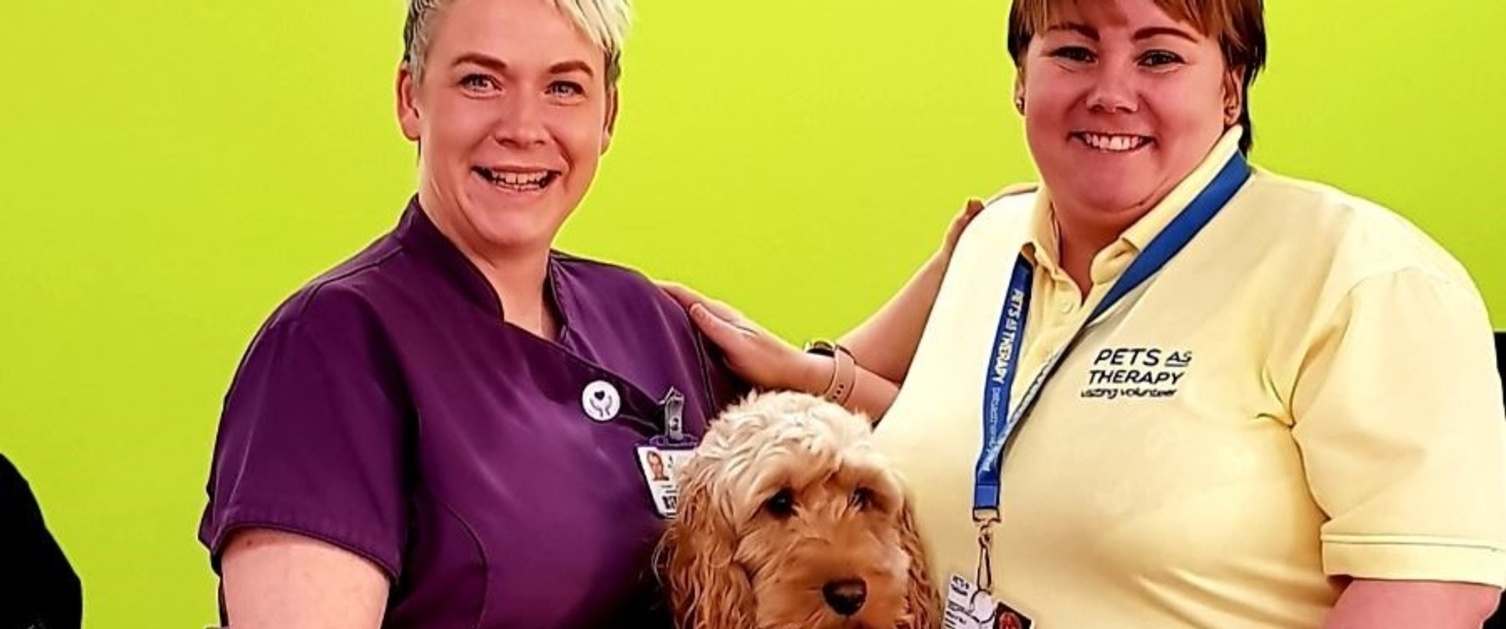 Morriston staff members Nicci Evans and Kelly Elt smiling at reception with dog Jax