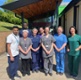 Image shows a group of people standing outside of a hospital entrance