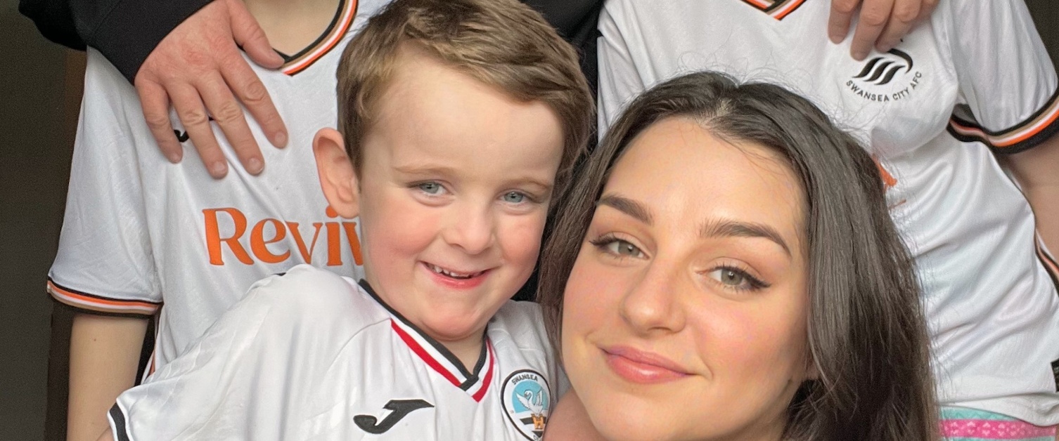 A family group, with three children wearing Swansea City kit