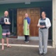 A man and two women stood outside a church