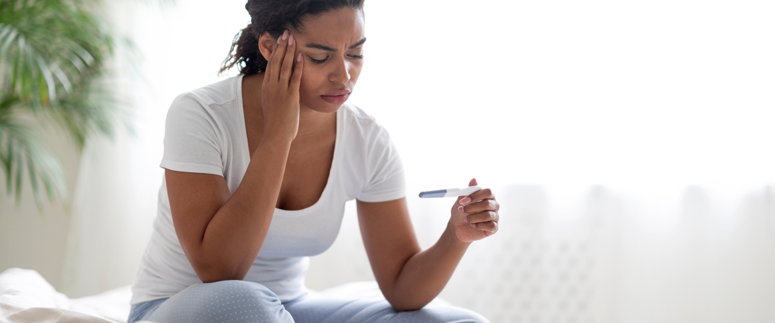 A woman looking at a pregnancy result