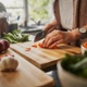 Picture of hands chopping a carrot.
