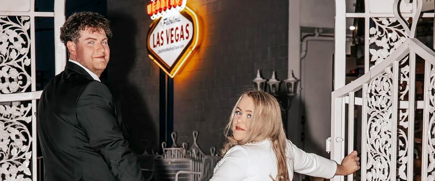 Liam and Jemma hold hands with a Las Vegas sign in the background