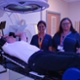 Image shows three staff and a patient in a radiotherapy room