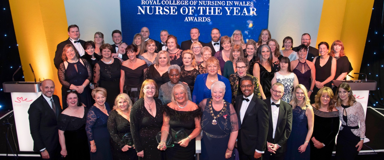 All of the RCN Wales Nurse of the Year winners are pictured together in front of a blue banner.