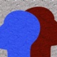 A blue and red face overlapping a grey background.