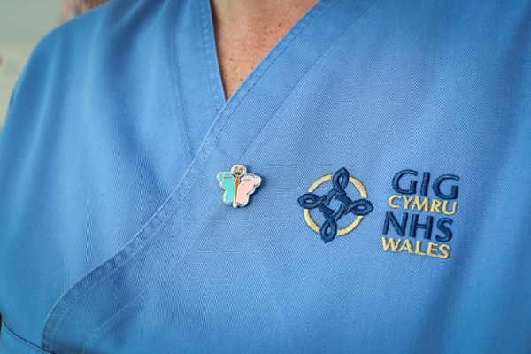 A picture of a badge, pinned to a nurse