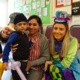 Surgery staff in fancy dress with a smiling mum and son
