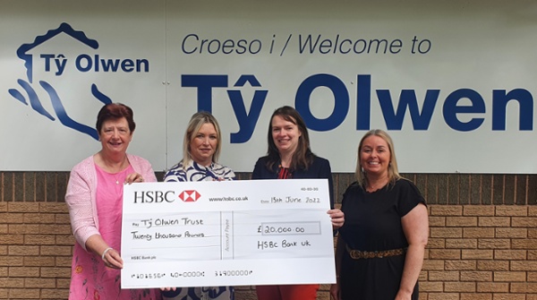 Four women holding a cheque