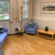Hospital quiet room with blue sofa and chairs and light soft furnishings