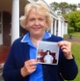 Christine Fitzgerald holding a photo of her in 1970