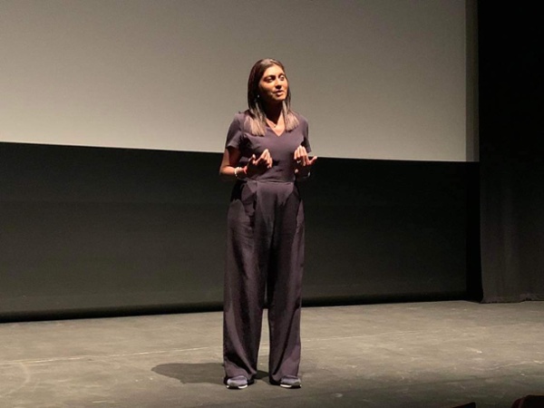 A woman giving a talk on stage