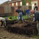 Volunteers take apart a raised flower bed in the grounds of Gorseinon Hospital.