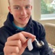Image shows a teenager with his hearing aid