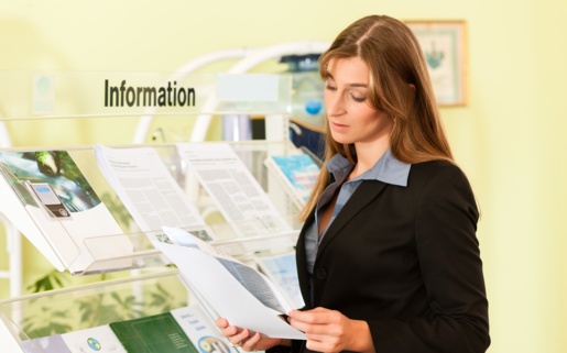 A woman looks at information leaflets.