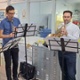 A violinist, a clarinet player and French horn player perform on a hospital ward.