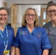 Image shows three midwives in a hospital corridor