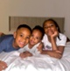 Image shows three children smiling