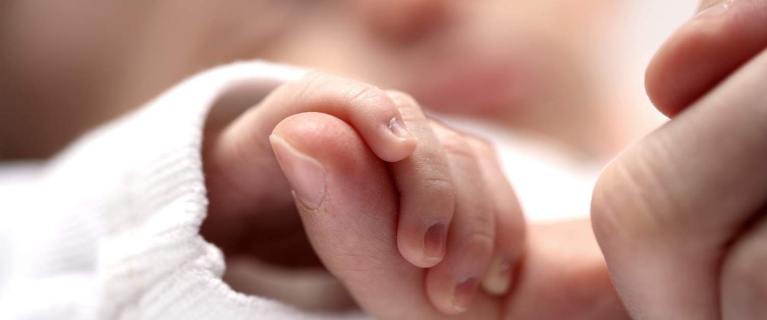 picture of baby holding adult finger